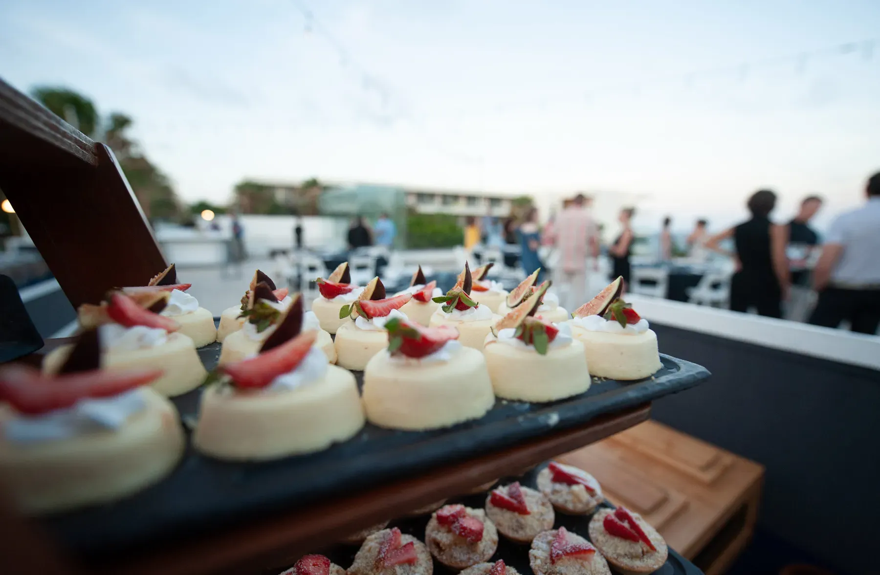 Trays of strawberry cheesecake bites at the rooftop sunset reception